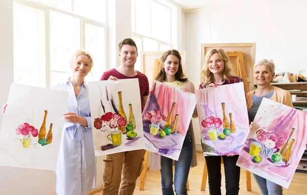 Group of artists with pictures at art school — Stock Photo, Image