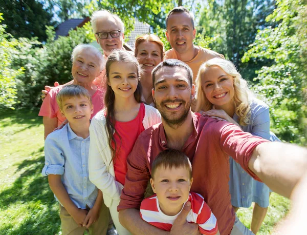 Happy family taking selfie in summer garden — Stock Photo, Image