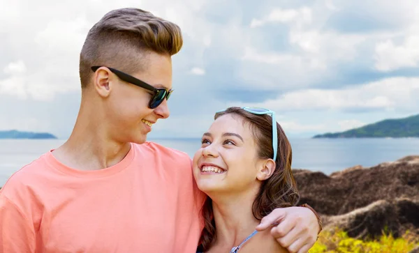 Happy teenage couple hugging outdoors — Stock Photo, Image