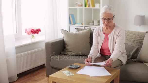 Senior woman with money and papers at home — Stock Video