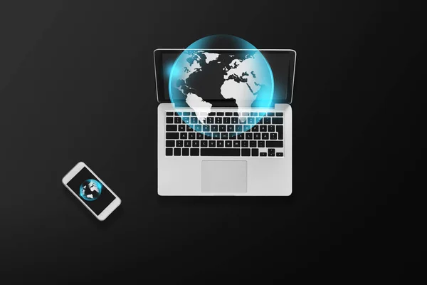 Laptop with earth projection and smartphone — Stock Photo, Image