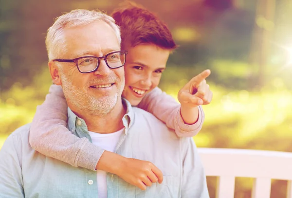Grandfather and boy pointing finger at summer park — Stock Photo, Image