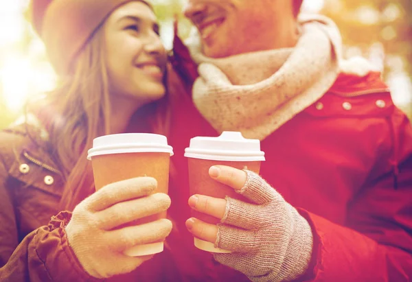 Close up of happy couple with coffee in autumn — Stock Photo, Image