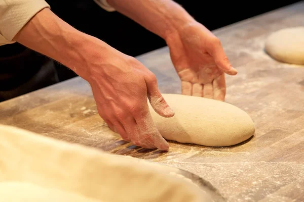 Chef or baker cooking dough at bakery — Stock Photo, Image