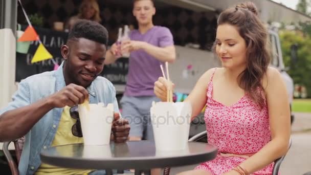 Glada vänner med drycker äta wok på foodtruck — Stockvideo