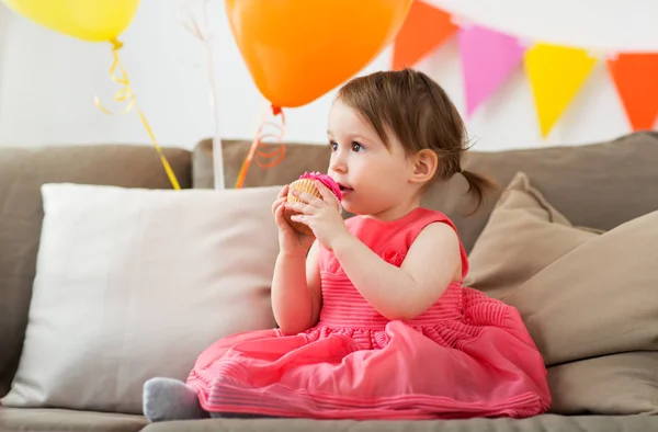 Feliz bebé niña comer cupcake en fiesta de cumpleaños —  Fotos de Stock