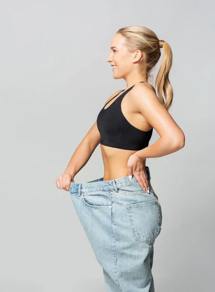 Junge schlanke, sportliche Frau in Oversize-Hosen — Stockfoto