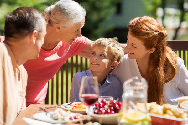 Happy family having dinner or summer garden party — Stock Photo, Image
