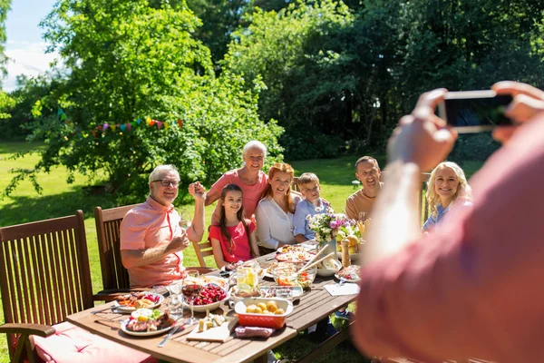 Happy family photographing by smartphone in summer — Stock Photo, Image