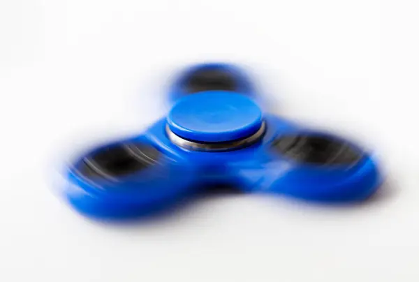 Close up of blue spinning fidget spinner — Stock Photo, Image