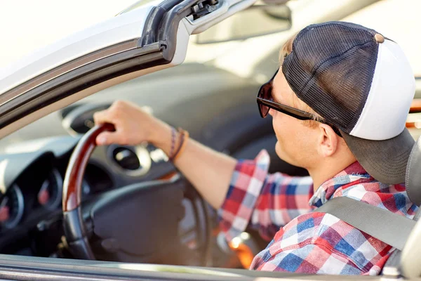 Happy young man in shades driving convertible car — Stock Photo, Image