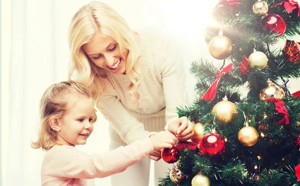 Happy family decorating christmas tree at home — Stock Photo, Image