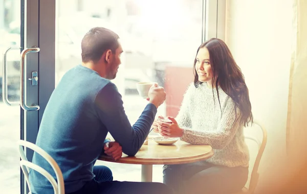 Happy couple drinking tea and coffee at cafe — Stock Photo, Image