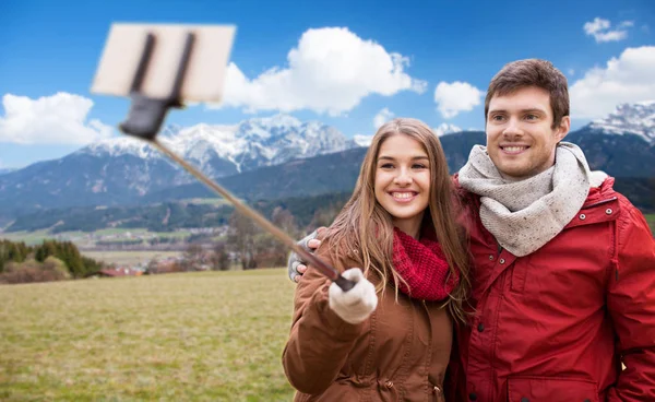 Couple taking selfie by smartphone over alps — Stock Photo, Image