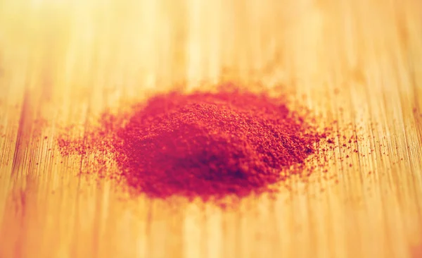 Cayenne pepper or paprika powder on wood — Stock Photo, Image