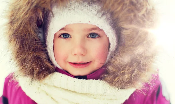 Face of happy little kid or girl in winter clothes Royalty Free Stock Photos