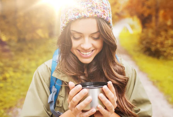 Sonriente joven con taza y mochila senderismo — Foto de Stock