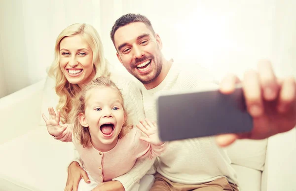 Family taking selfie with smartphone at home — Stock Photo, Image