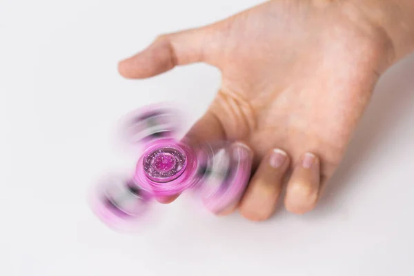 Close up of hand playing with fidget spinner — Stock Photo, Image
