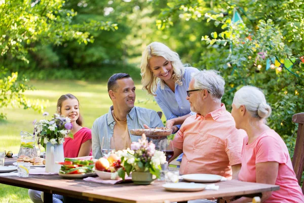 Happy family having dinner or summer garden party — Stock Photo, Image