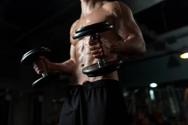 Close up of man with dumbbells exercising in gym — Stock Photo, Image