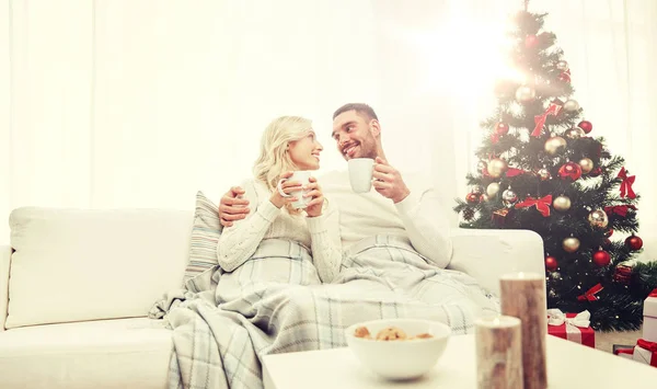 Happy couple at home with christmas tree — Stock Photo, Image