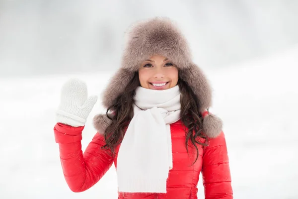 Lycklig kvinna i vinter päls hatt viftande hand utomhus — Stockfoto