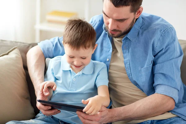 Father and son with tablet pc playing at home — Stock Photo, Image