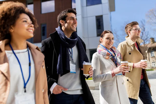 People with coffee and conference badges in city — Stock Photo, Image