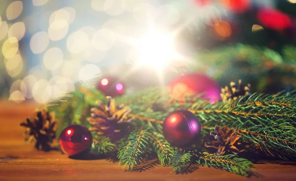 Fir branch with christmas ball and pinecones — Stock Photo, Image