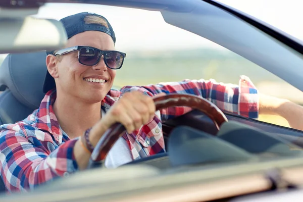 Feliz joven en tonos de conducción coche descapotable — Foto de Stock