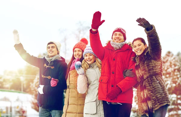 Happy friends waving hands outdoors — Stock Photo, Image