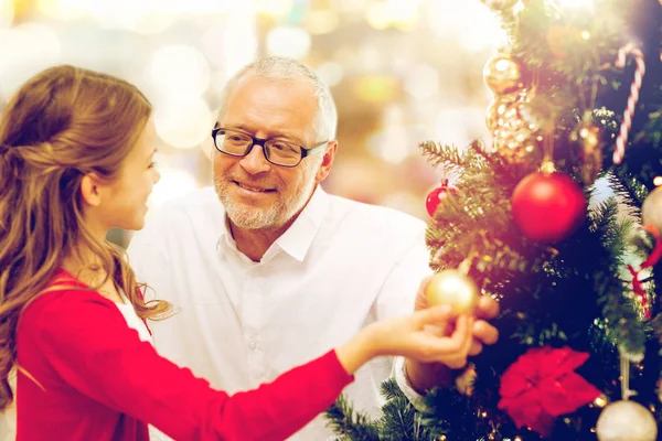 Grandfather and granddaughter at christmas tree — Stock Photo, Image
