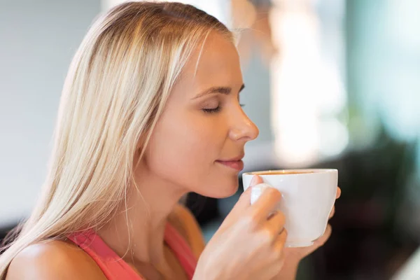 Close up of woman drinking coffee at restaurant — Stock Photo, Image