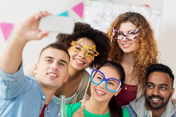 Happy team taking selfie at office party — Stock Photo, Image