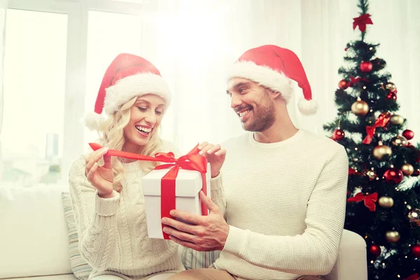 Feliz pareja en casa con caja de regalo de Navidad — Foto de Stock