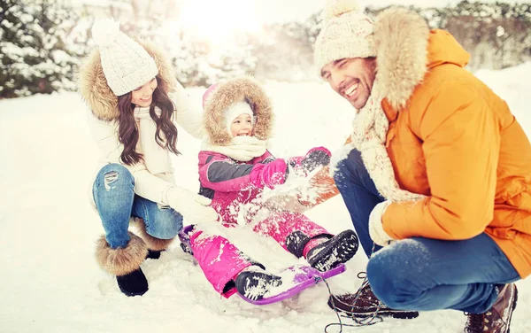 Familia feliz con niño en trineo divertirse al aire libre —  Fotos de Stock