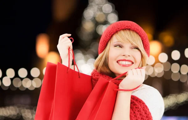 Mulher feliz com sacos de compras sobre a árvore de Natal — Fotografia de Stock