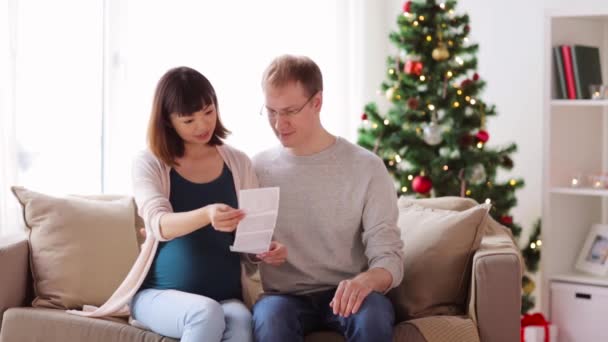 Feliz pareja con imágenes de ultrasonido en Navidad — Vídeos de Stock