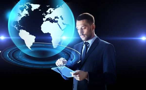 Businessman with tablet pc and earth hologram — Stock Photo, Image