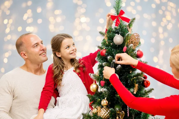 Mother, father and daughter at christmas tree — Stock Photo, Image