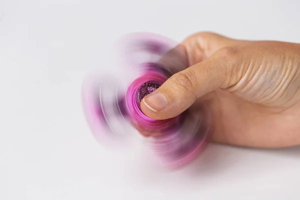 Close up of hand playing with fidget spinner — Stock Photo, Image