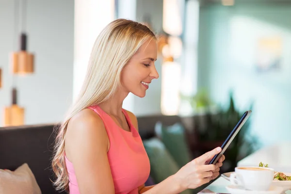 Felice giovane donna con tablet pc al ristorante — Foto Stock