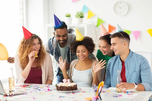 team greeting colleague at office birthday party