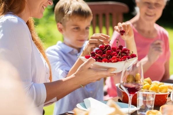 Glad familj som äter middag eller sommarträdgårdsfest — Stockfoto