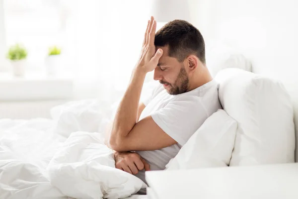 Stressed man in bed at home — Stock Photo, Image