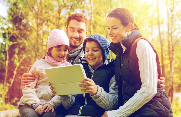 Happy family with tablet pc at camp — Stock Photo, Image