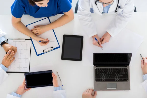 Doctors with cardiogram and computers at hospital — Stock Photo, Image