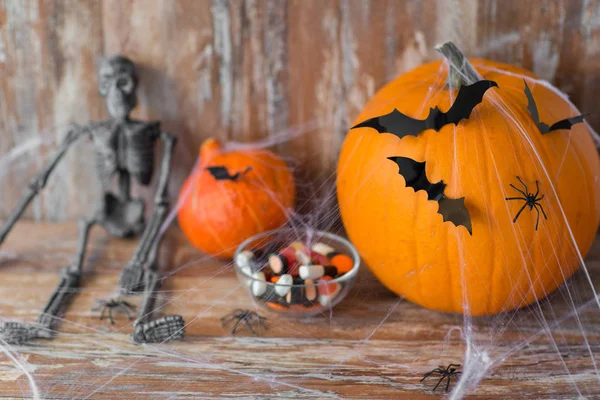Halloween pumpkins, skeleton and candies — Stock Photo, Image