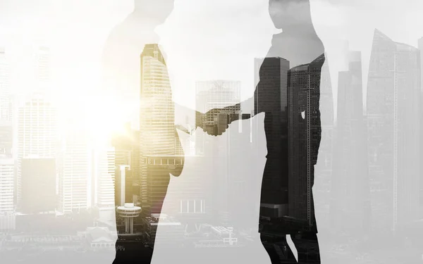 Business people shaking hands over city background — Stock Photo, Image